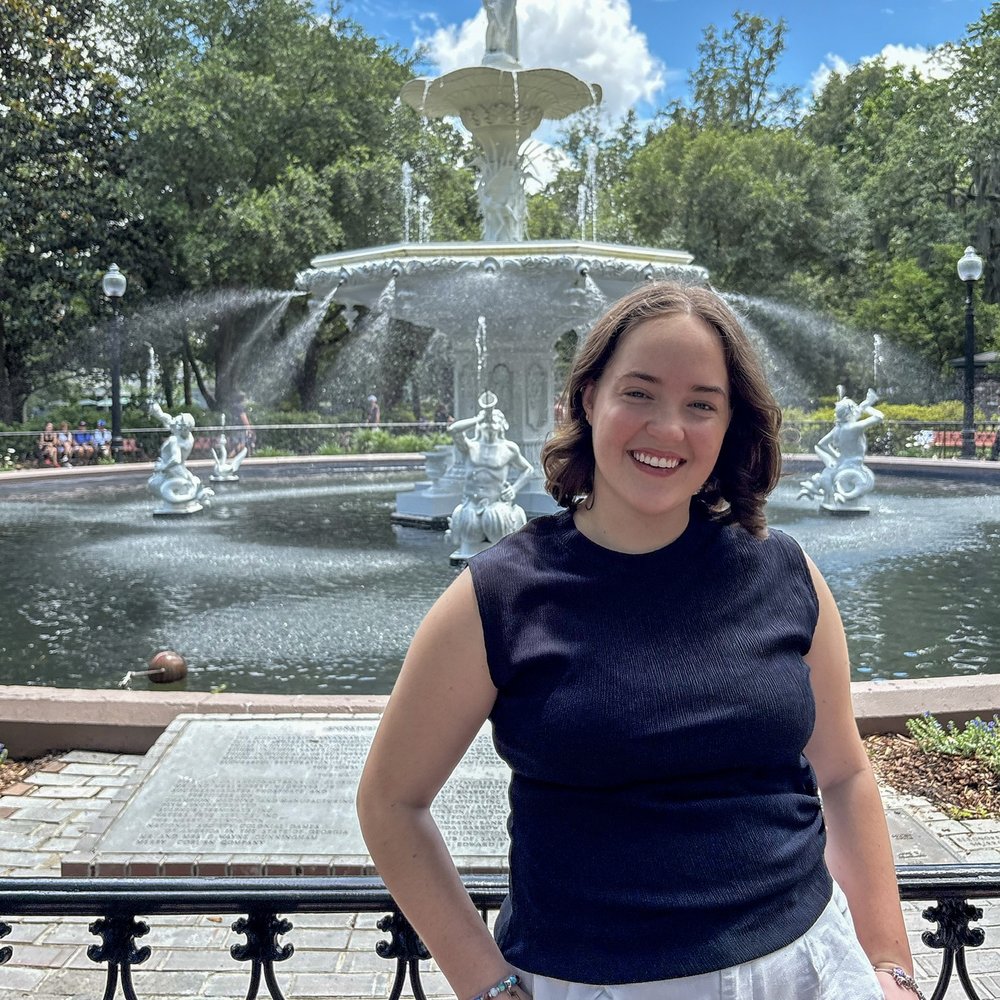 Riley Willard smiling in front of the Forsyth Park fountain in Savannah, Georgia